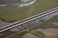 A photo of a long bridge spanning over wetlands in Louisiana.