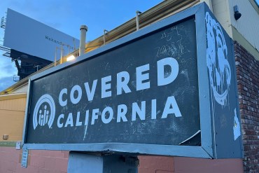 A photo of a sign advertising Covered California, the state's Affordable Care Act marketplace, in Los Angeles.