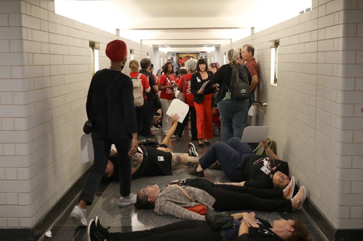 A photo of a die-in staged at a statehouse.