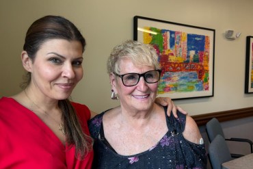 A photo of an older woman posing with a younger woman.