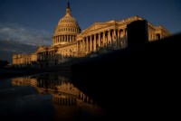 A photo of the US Capitol building at sunrise.
