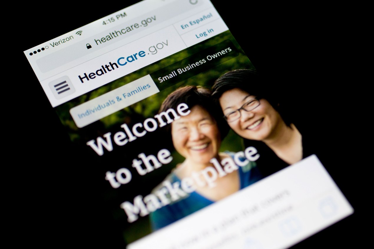 A photo of a phone screen showing the HealthCare.gov website.