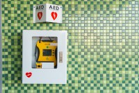 A photo of a cabinet containing an AED mounted on the wall.