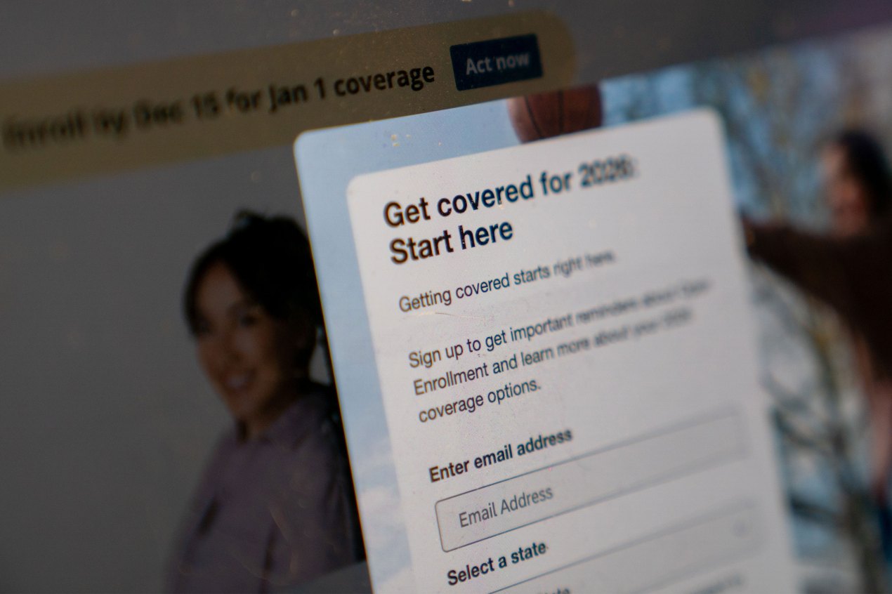 A photo of HealthCare.gov's website. A pop-up form reads, "Get covered for 2026. Start here."