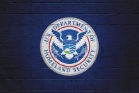The emblem of the U.S. Department of Homeland Security is painted on a wall.