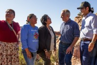 A photo of Navajo tribal members meeting with Robert F. Kennedy Jr. outside.